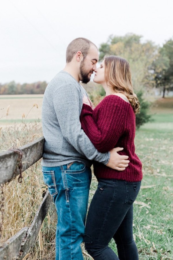 Taking pictures of your love while dressed in the appropriate engagement outfit of a marron sweater and denim may be a wonderful experience