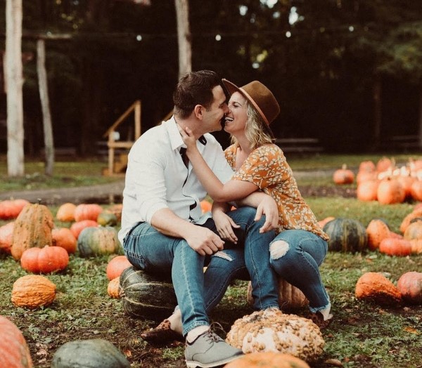 They posed for a lovely autumn engagement shot on a pumpkin patch