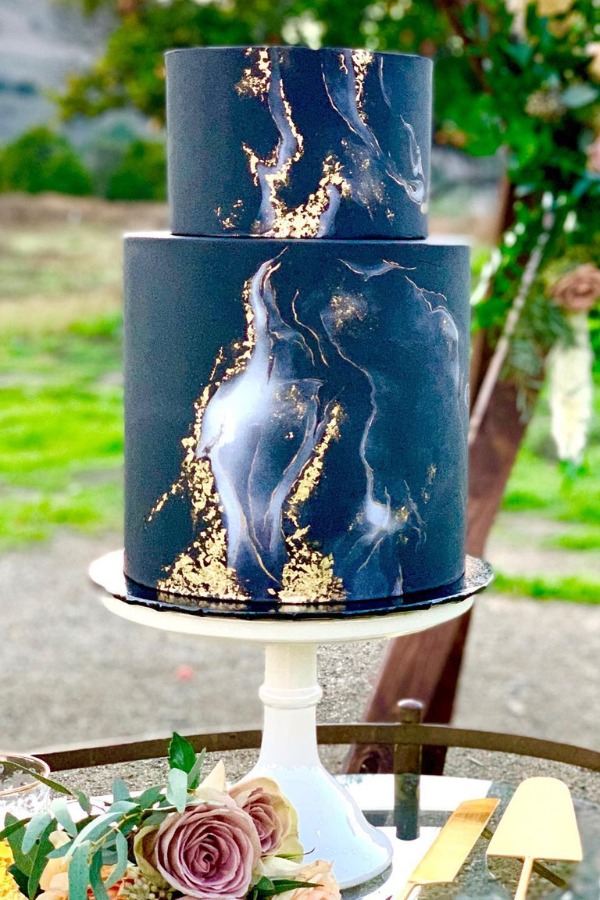 This cigar smoke inspired black geode wedding cake adds elegance to the event