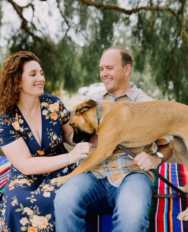 With their loving dog at their side this joyful couple celebrates their engagement as there is love in the air