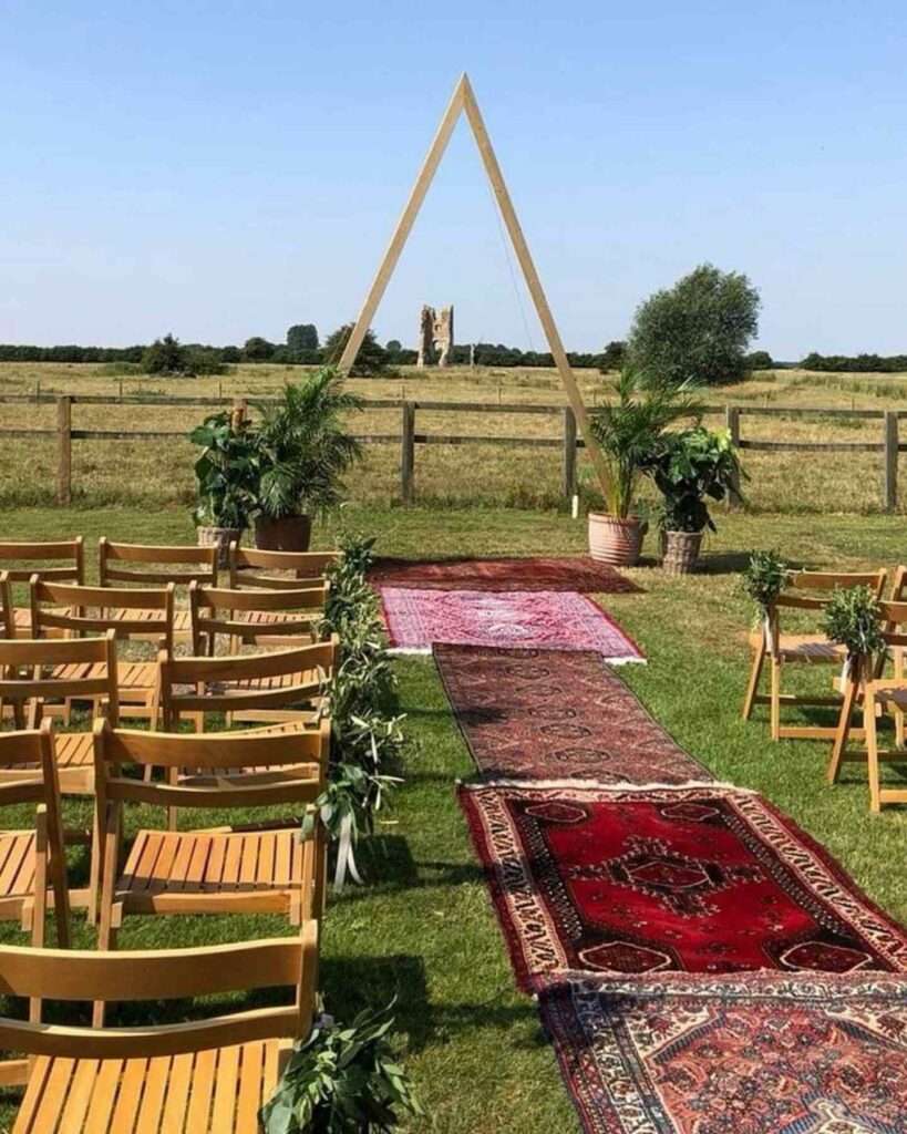 boho wedding aisle décor with Persian rugs
