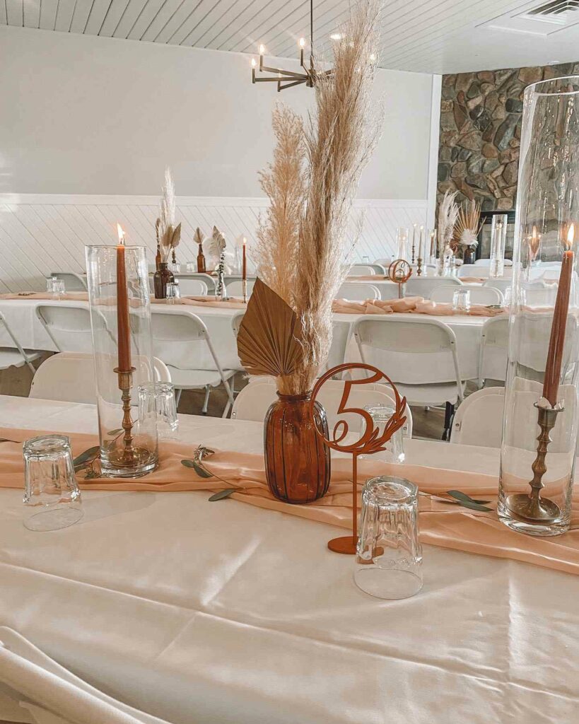 dried palm leaves and pampas grass boho wedding centerpiece with candle stick