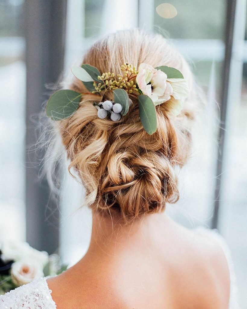 messy bun boho flower adorn wedding hairdo