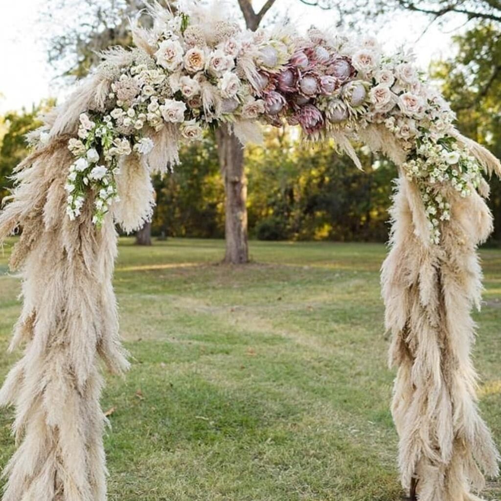 pampas grass and fresh flowers boho garden wedding arch