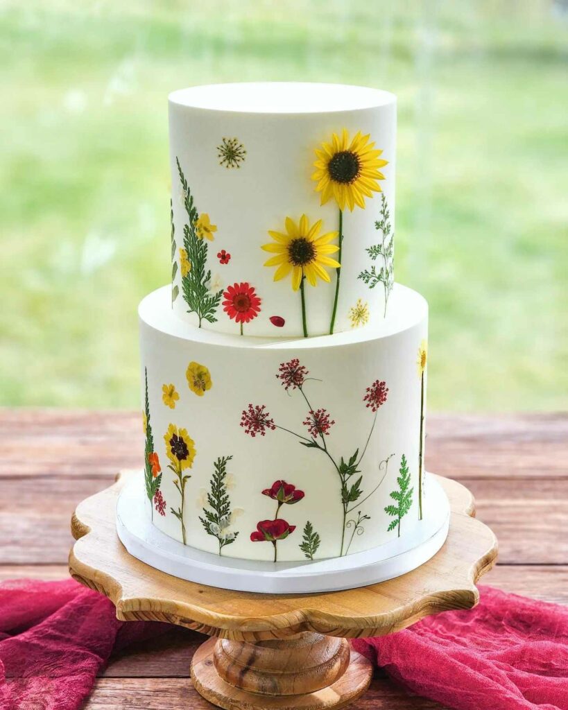 elegant romantic pressed sunflower wedding cake