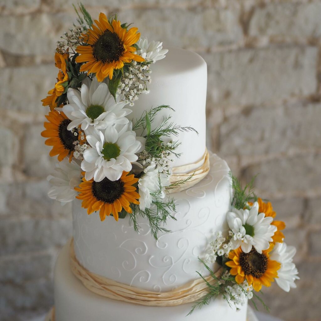 elegant sunflower theme with white floral wedding cake ideas