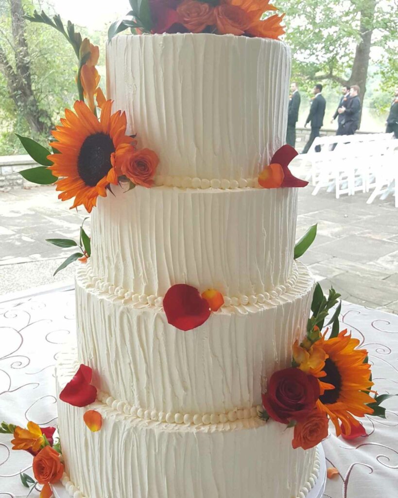 fall themed multi tiered sunflower outdoor wedding cake