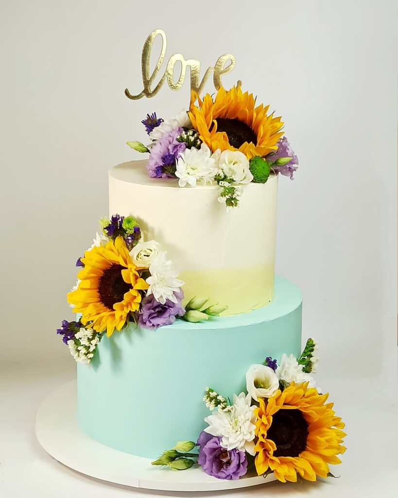 romantic floral and sunflower sea green wedding cake