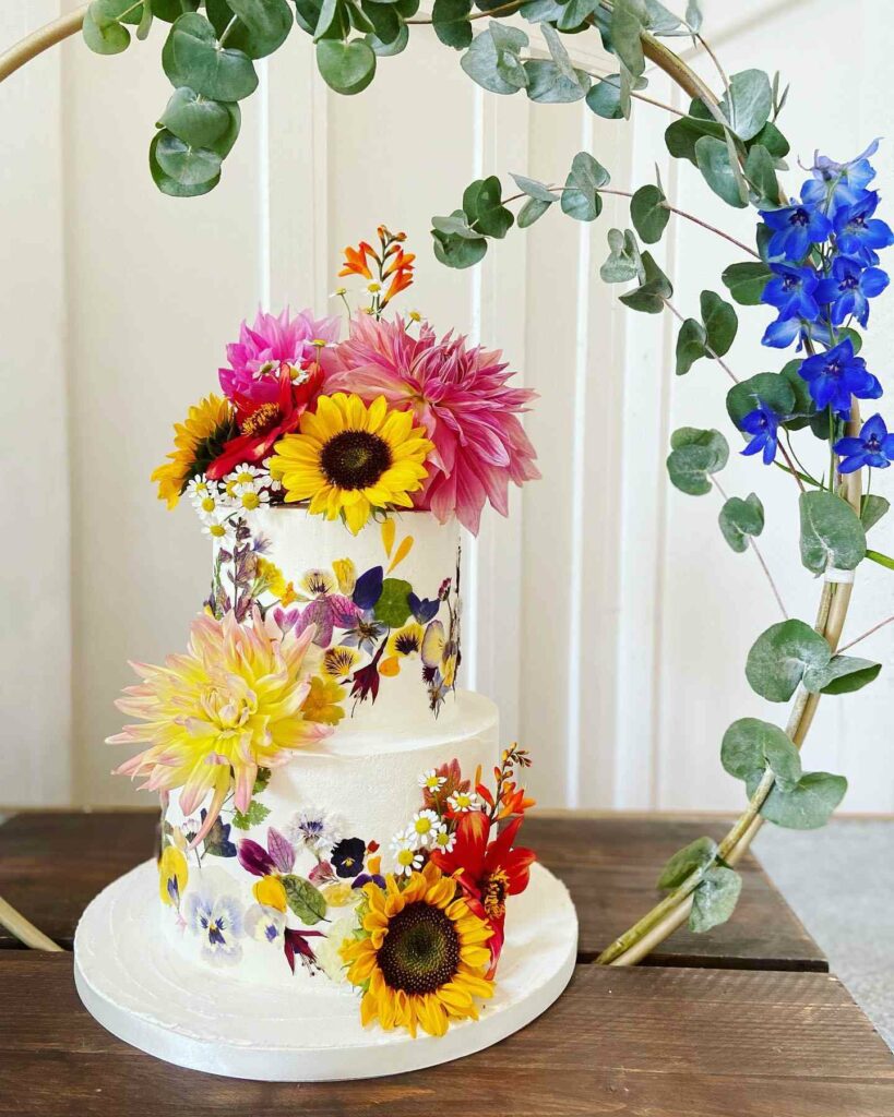 romantic sunflower wedding cake with pressed edible flower