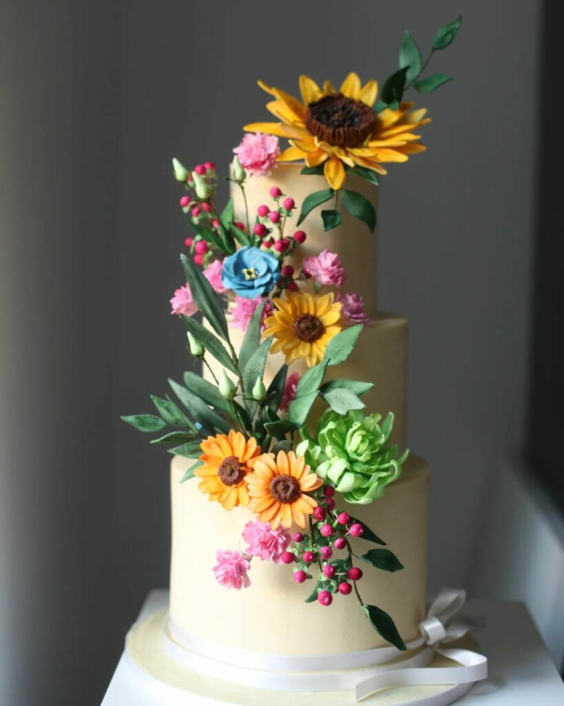 romantic sunflower with abundance of sugar flowers wedding cake