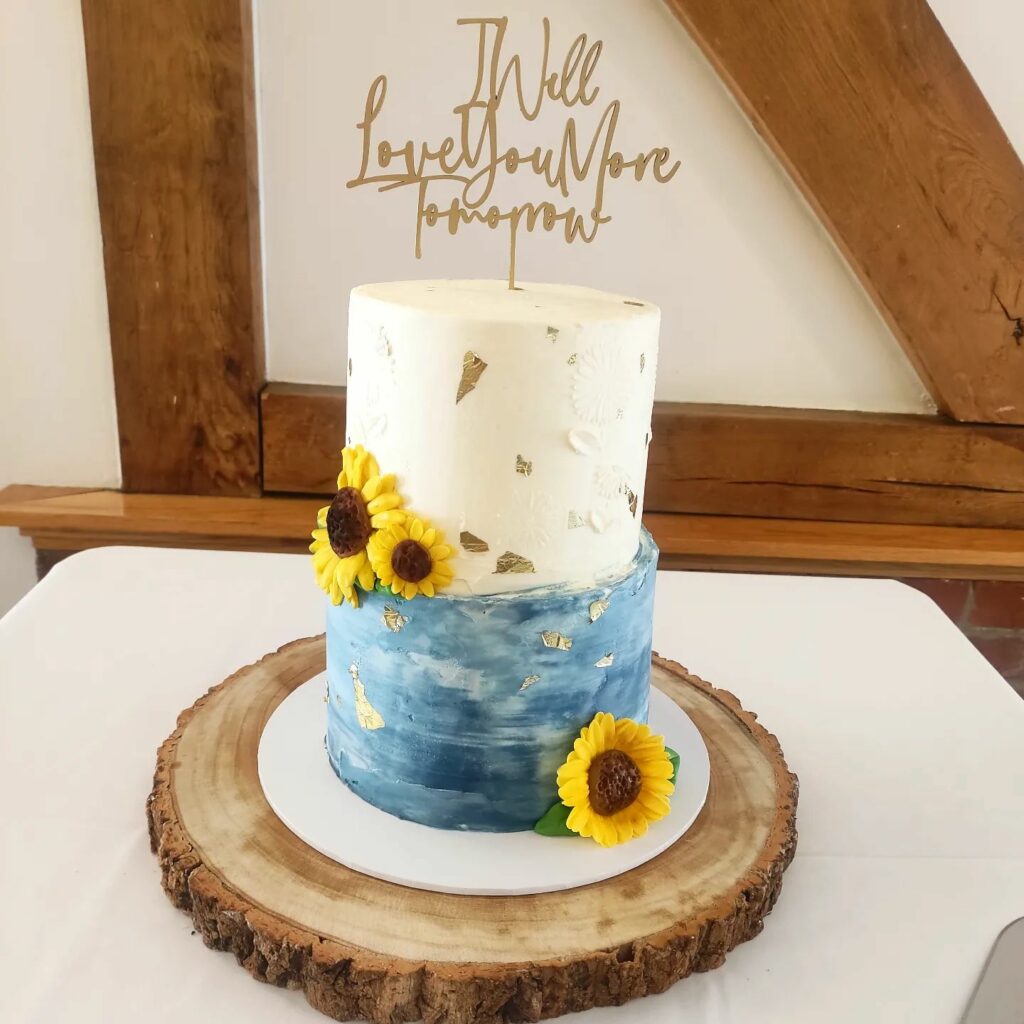 stenciled sunflower and gold leaf dusty blue wedding cake