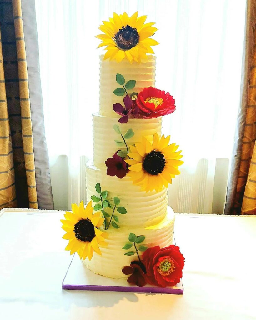 sunflower 4-tiered wedding cake with roses