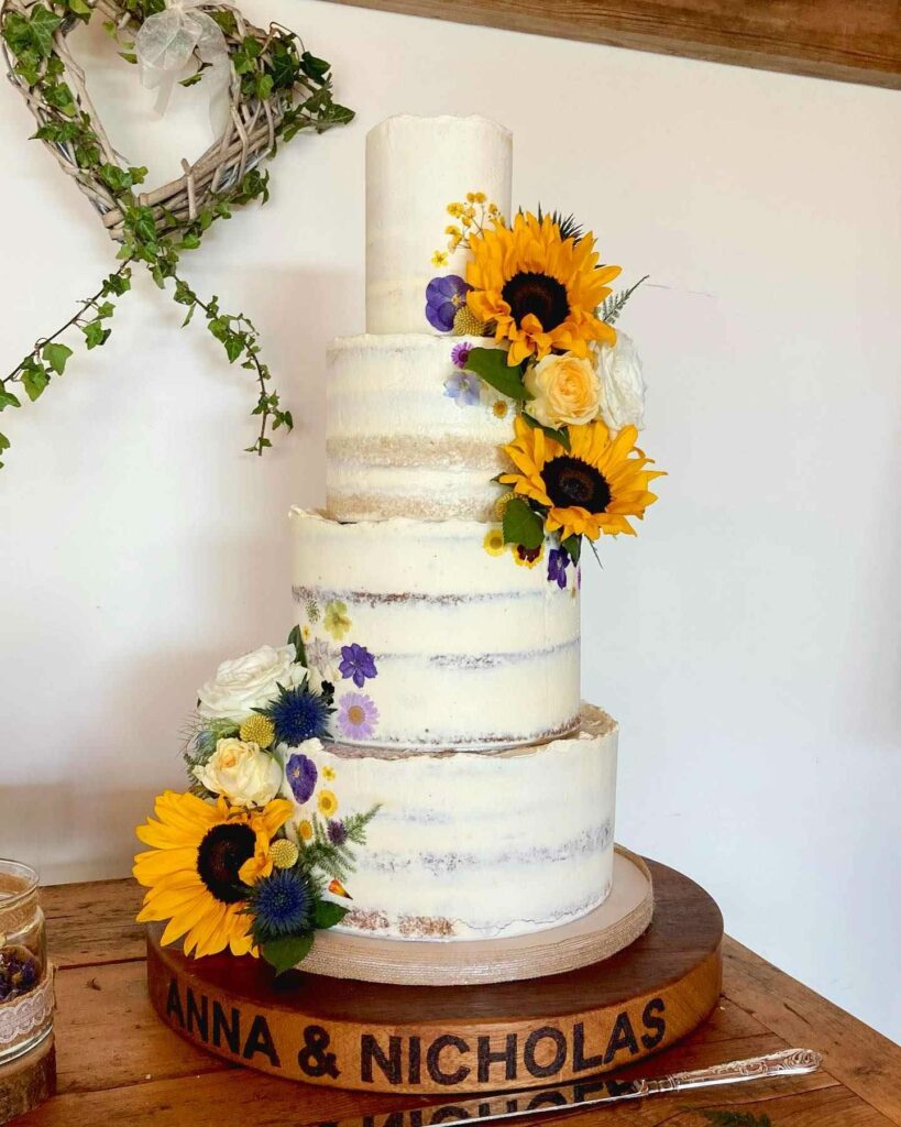 sunflower and pressed wildflowers tiered wedding cake