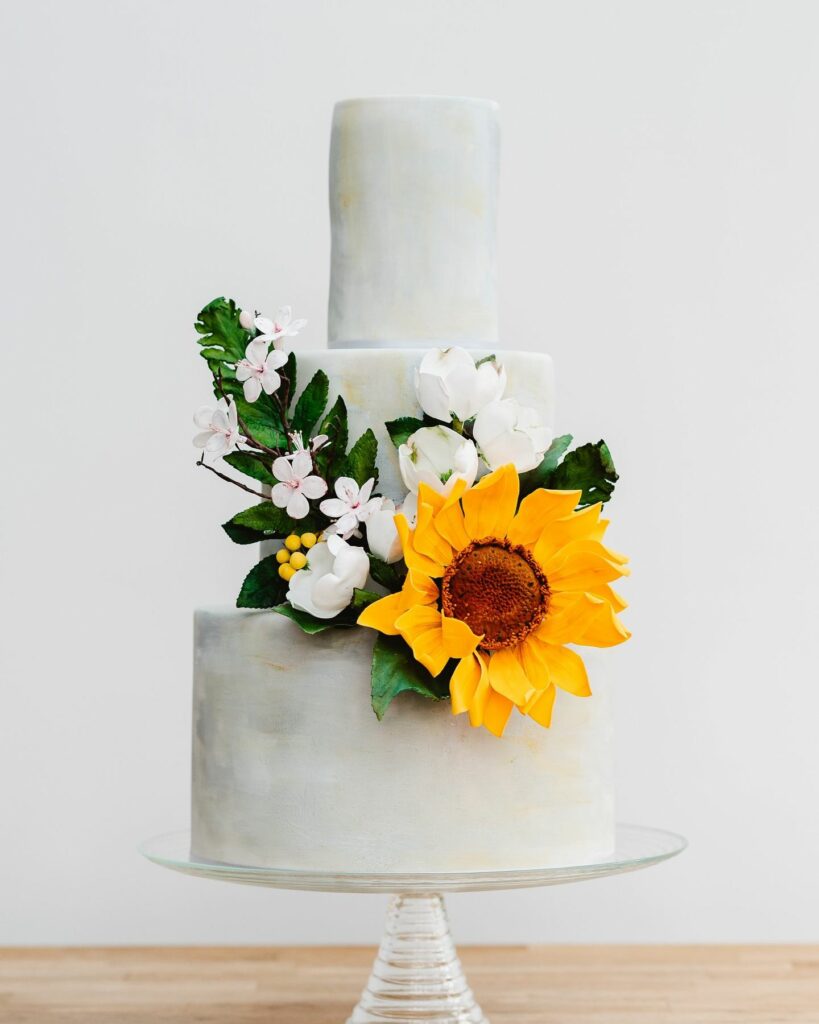 sunflower combined with apple blossom and dogwood roses wedding cake