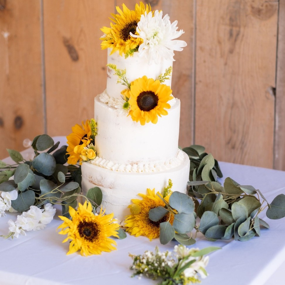 sunflower country wedding cake with natural greenery