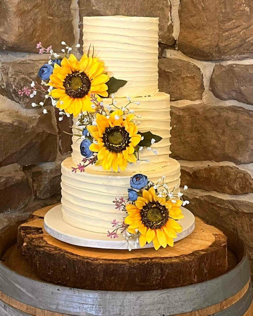 sunflower decorated rustic wedding cake with buttercream