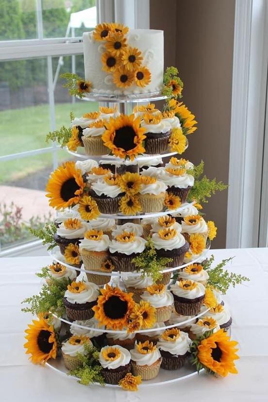 sunflower outdoor wedding cake and cupcake tower with floral
