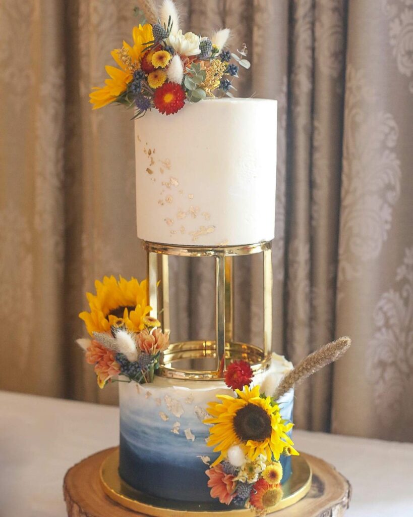 two tier sunflower wedding cake idea with gold tier separator