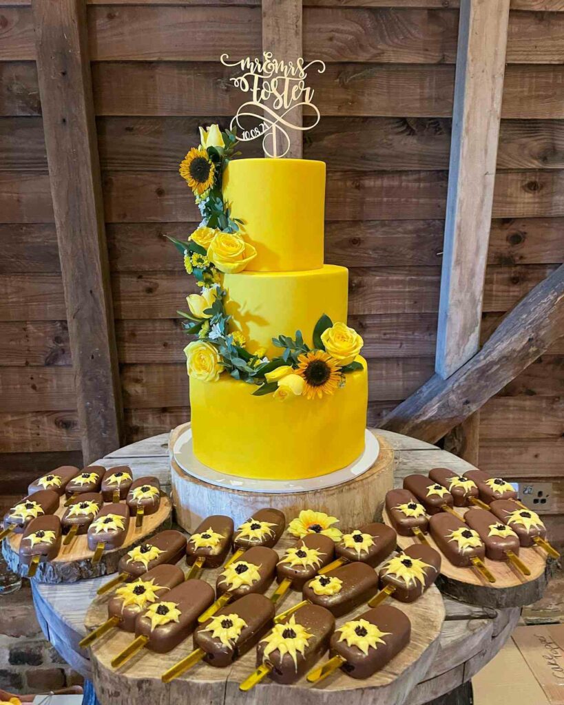 yellow sunflower rustic wedding cake with ice pops