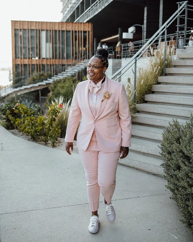 beautiful black lesbian bride in pink wedding suit