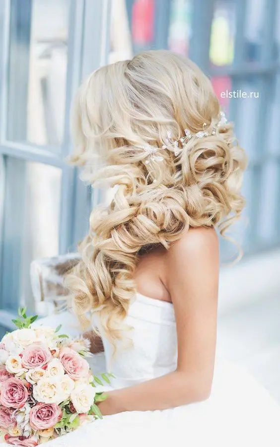 blonde half up side swept curls wedding hairstyle with a beaded hairpiece