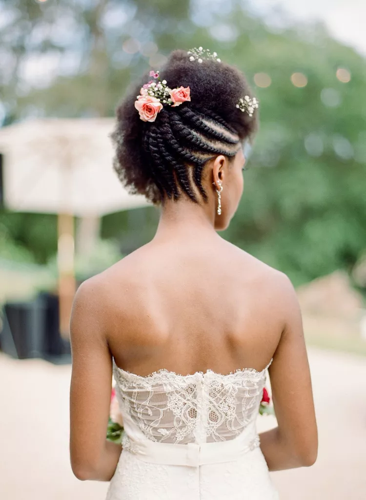 box braid wedding hairstyle with burst of peachy roses