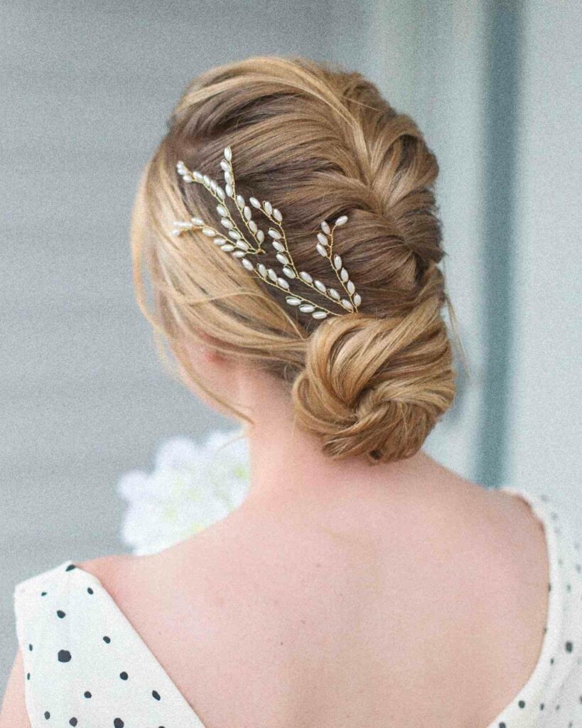 braided low bun wedding hairstyle for spring wedding