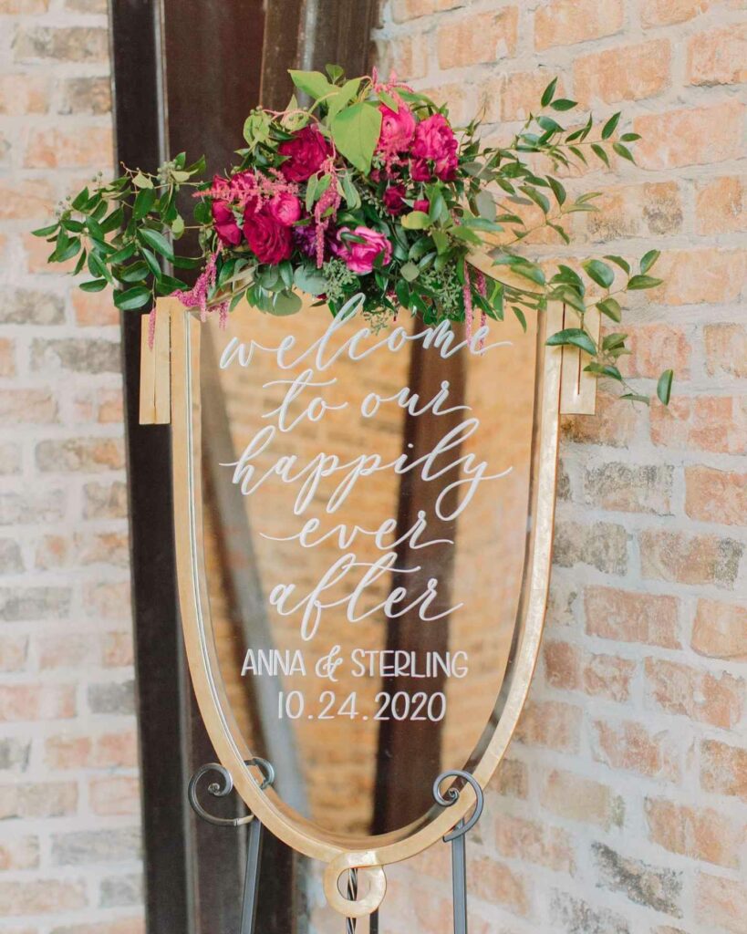 calligraphy flowers adorn mirror welcome sign for vintage wedding