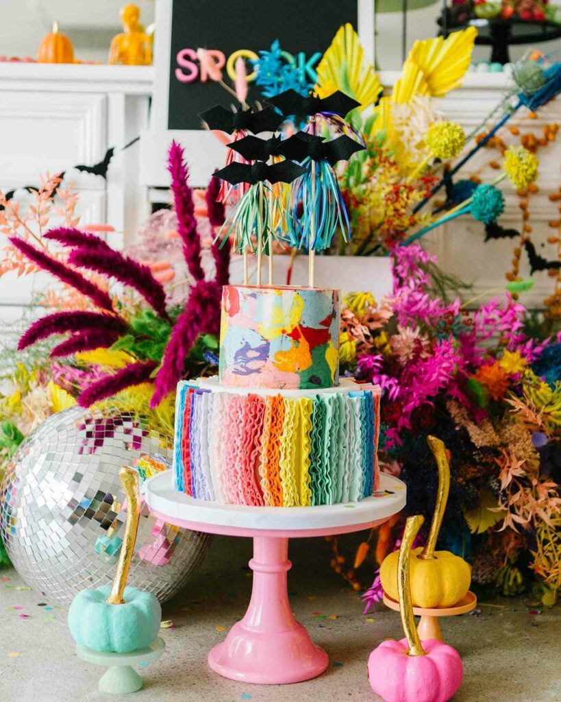 delicious two tiered rainbow wedding cake with floral décor