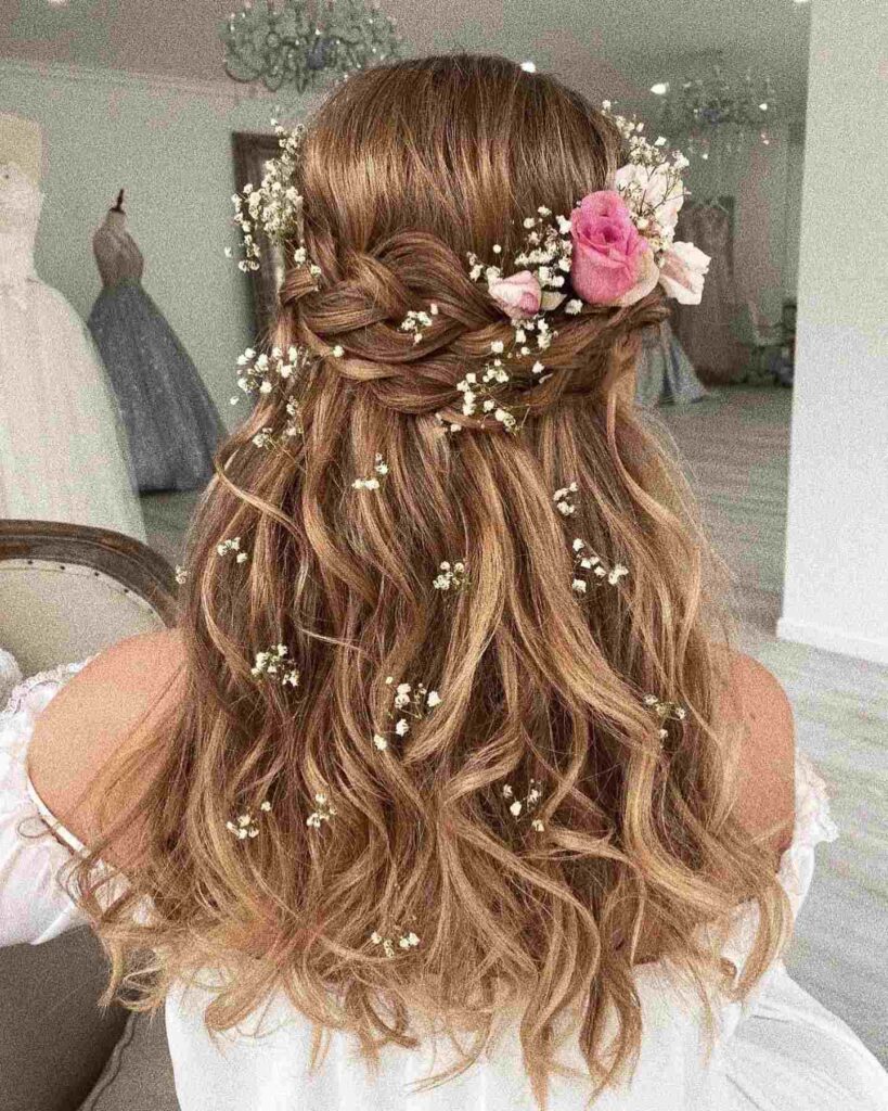 half up half down braided hairstyle for wedding with fresh flowers