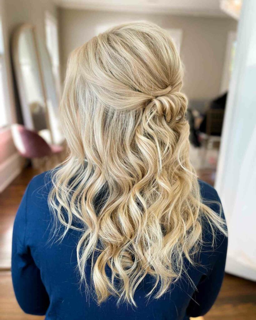 half up half down bridesmaid hairstyle with beachy waves and knotted bun