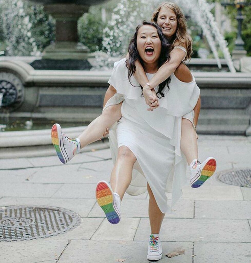 happy lesbian brides in rainbow wedding sneakers