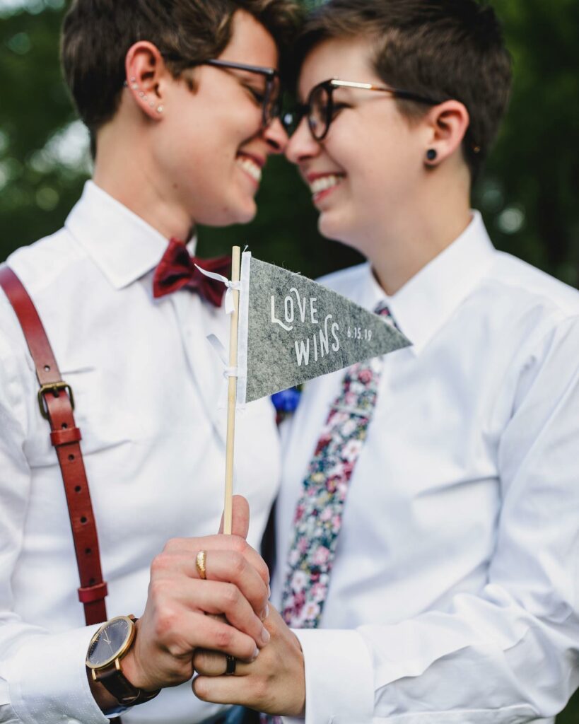 LGBTQ+ couple with love wins wedding sign