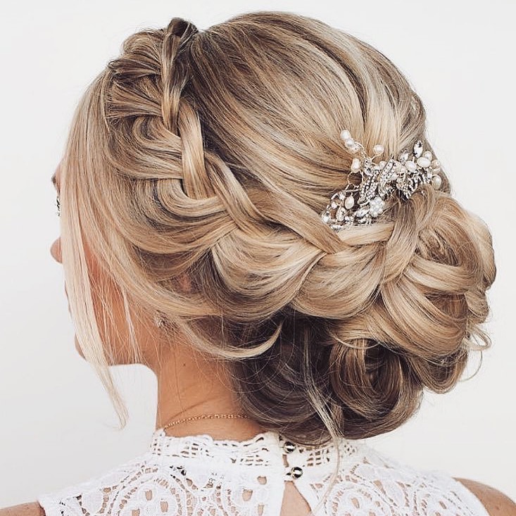 low curly back bun wedding hairstyle with braids