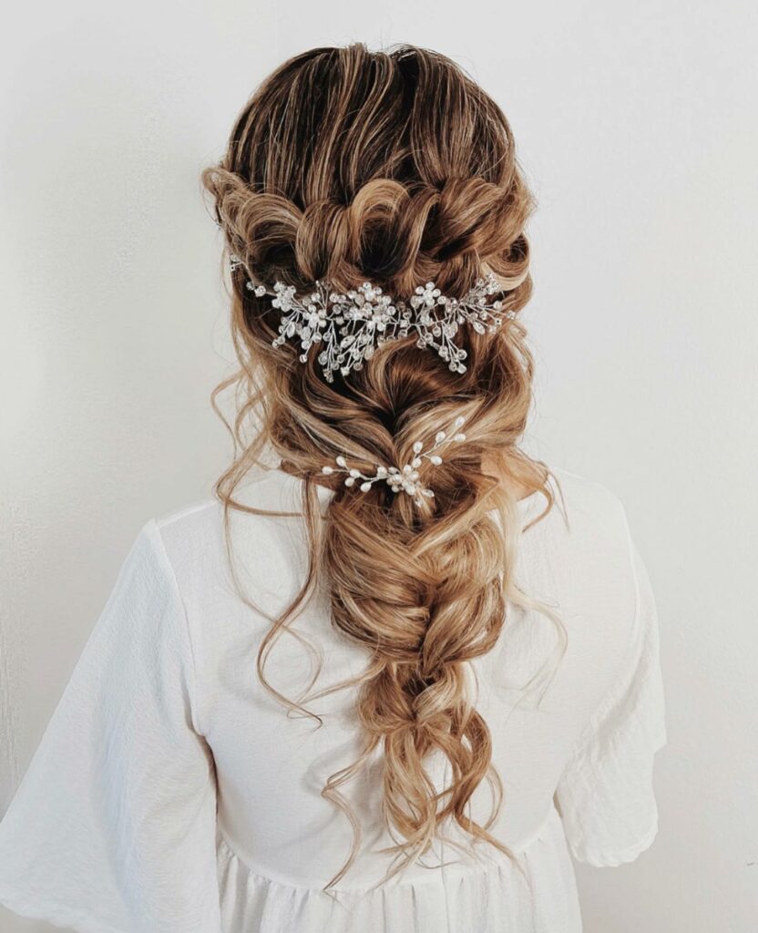 messy loose curl braided hairstyle for wedding with hair piece