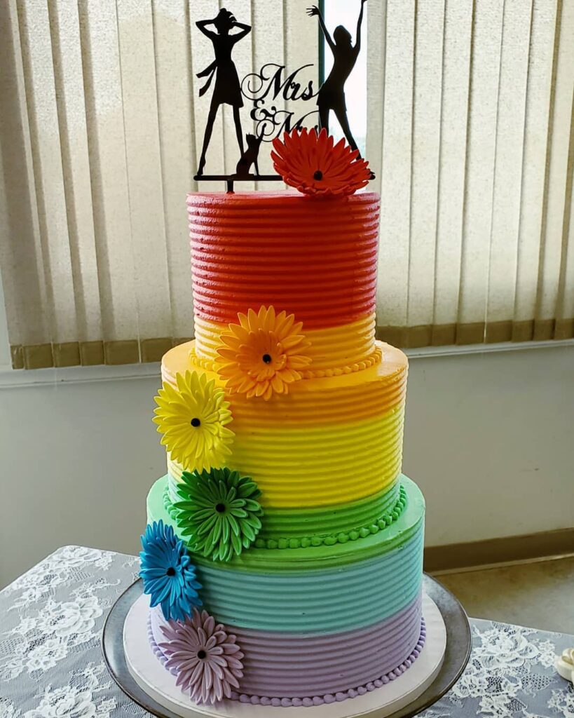 Mrs. and Mrs. sugar three tiered rainbow same sex wedding cake