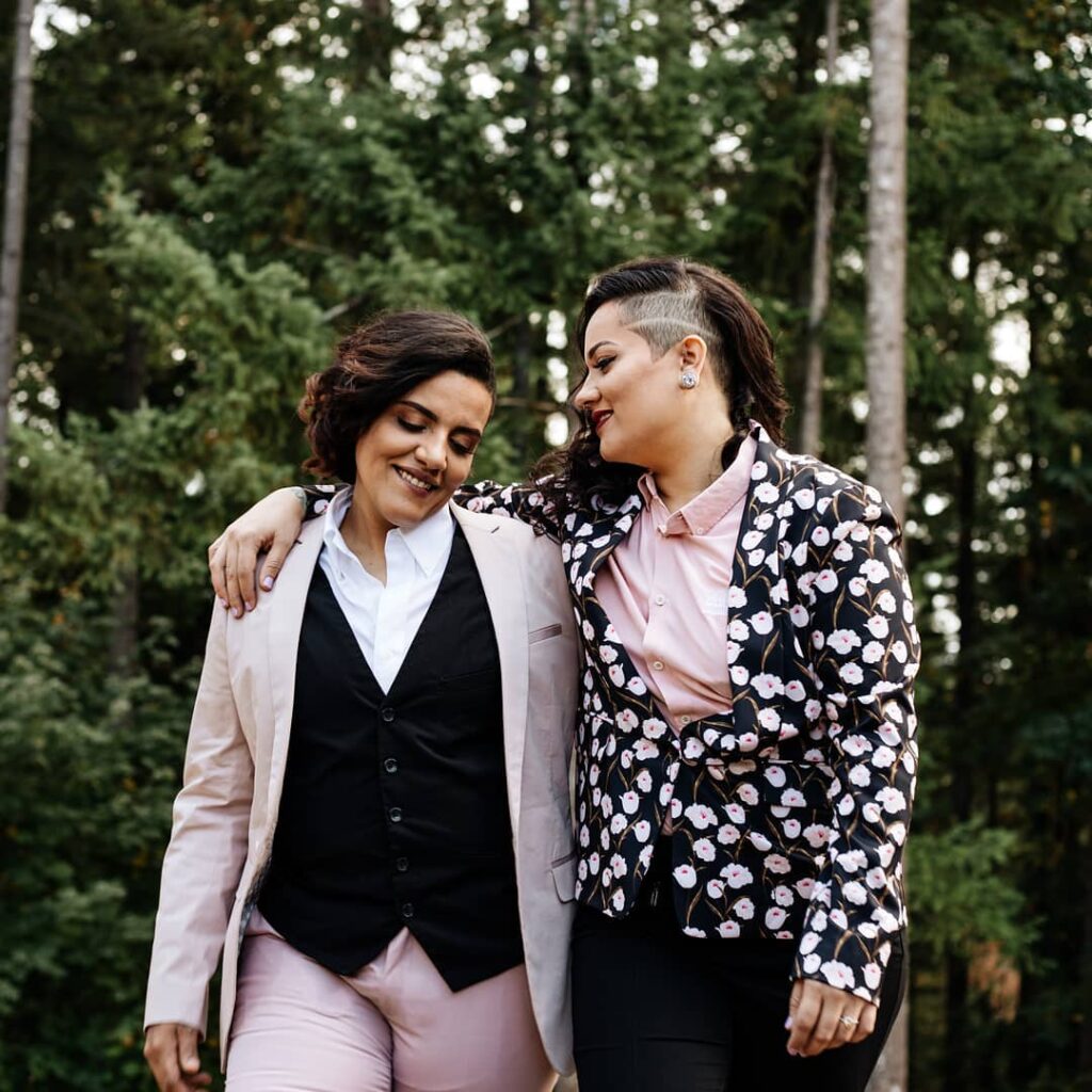 pink and black themed lesbian wedding suits