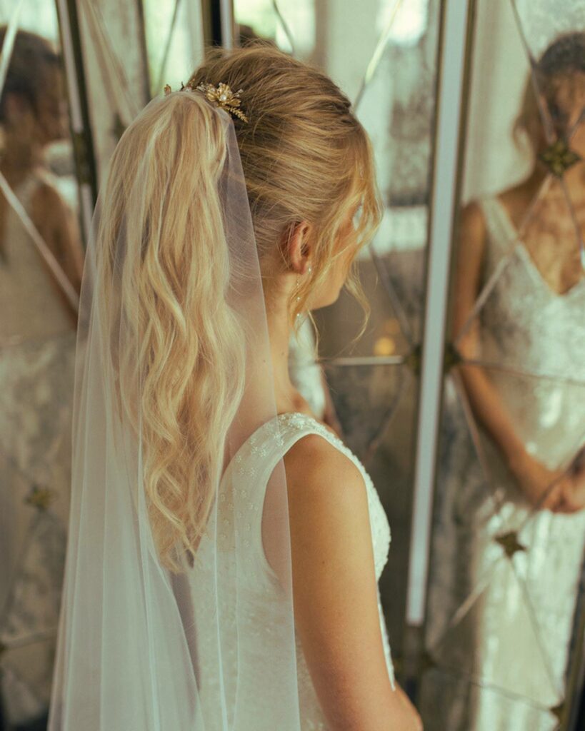 ponytail minimalist bride wedding hairstyle for thin hair with chapel veil