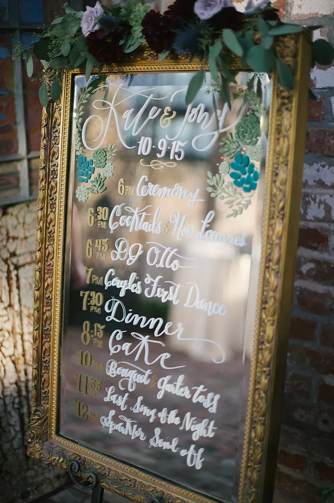 pretty mirror with golden frame wedding timeline sign
