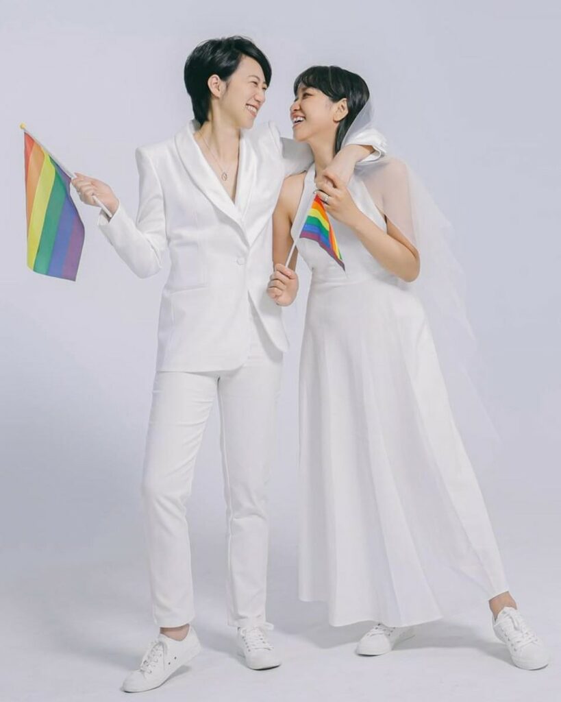 pride lesbian brides outfits with rainbow flags