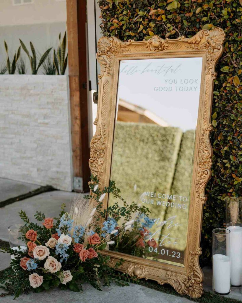 selfie mirror trendy welcome signage with floral arrangement