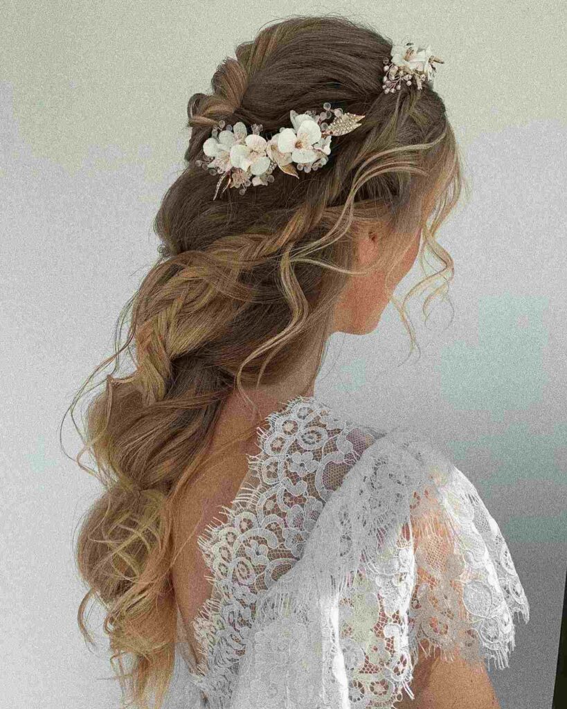 soft bohemian braided wedding hairstyle with flower accessories