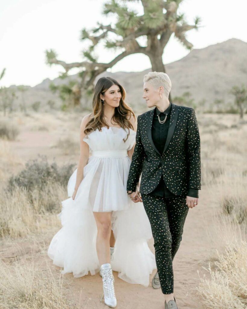 sparkling black suit and white short lesbian wedding gown