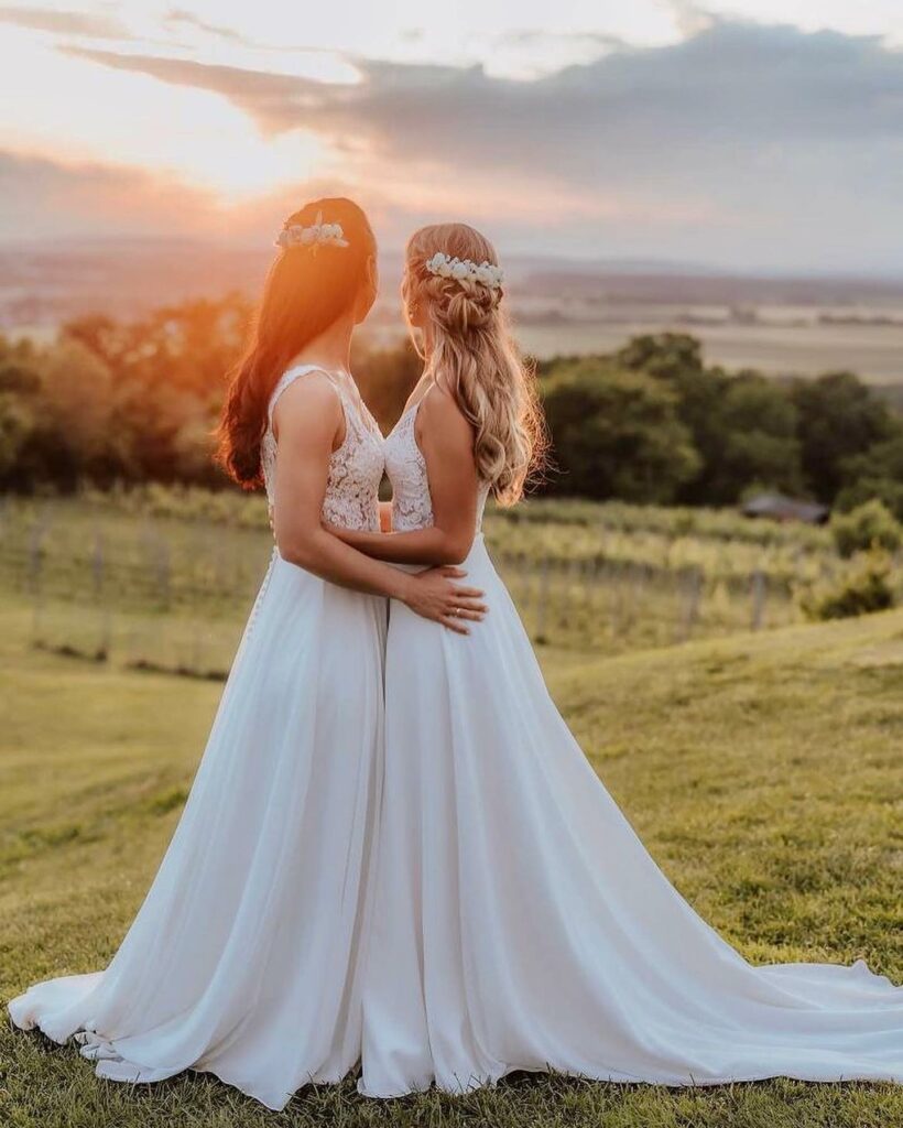 the sun setting on this gorgeous lesbian wedding and the beauty of two brides in love