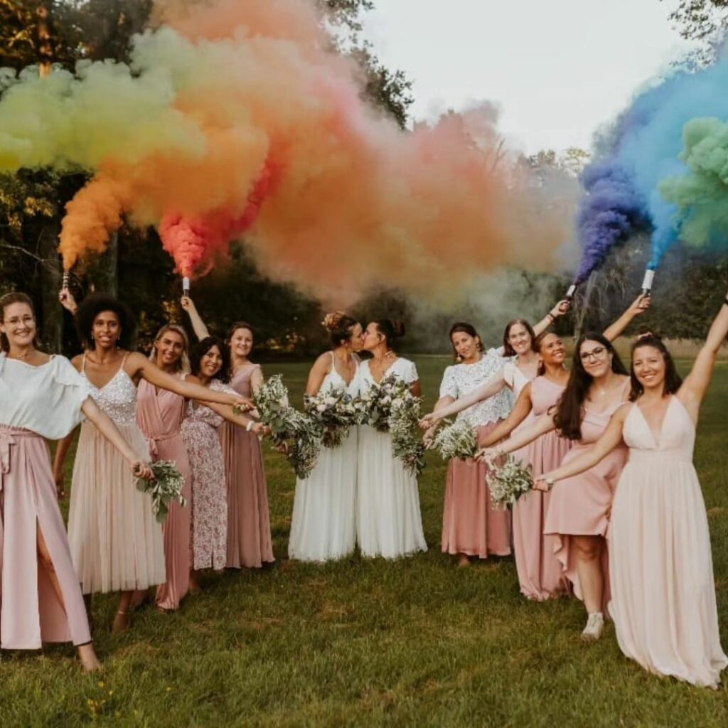 these gorgeous lesbian brides and their blush dressed wedding party shine in the rustic charm
