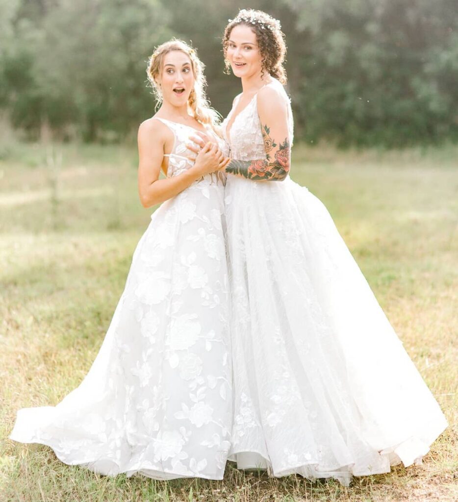 two beautiful lesbian brides in princess lace wedding gown