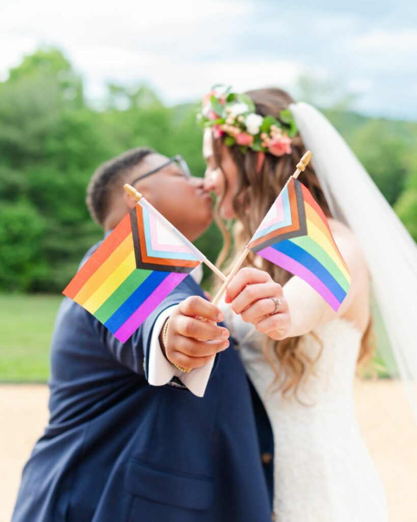 two lovely lesbian brides celebrate loves victory in a real wedding that radiates equality unity and joy under the rainbow flag