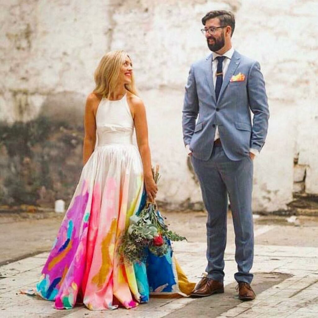 hand painted rainbow wedding dress with beautiful bouquet