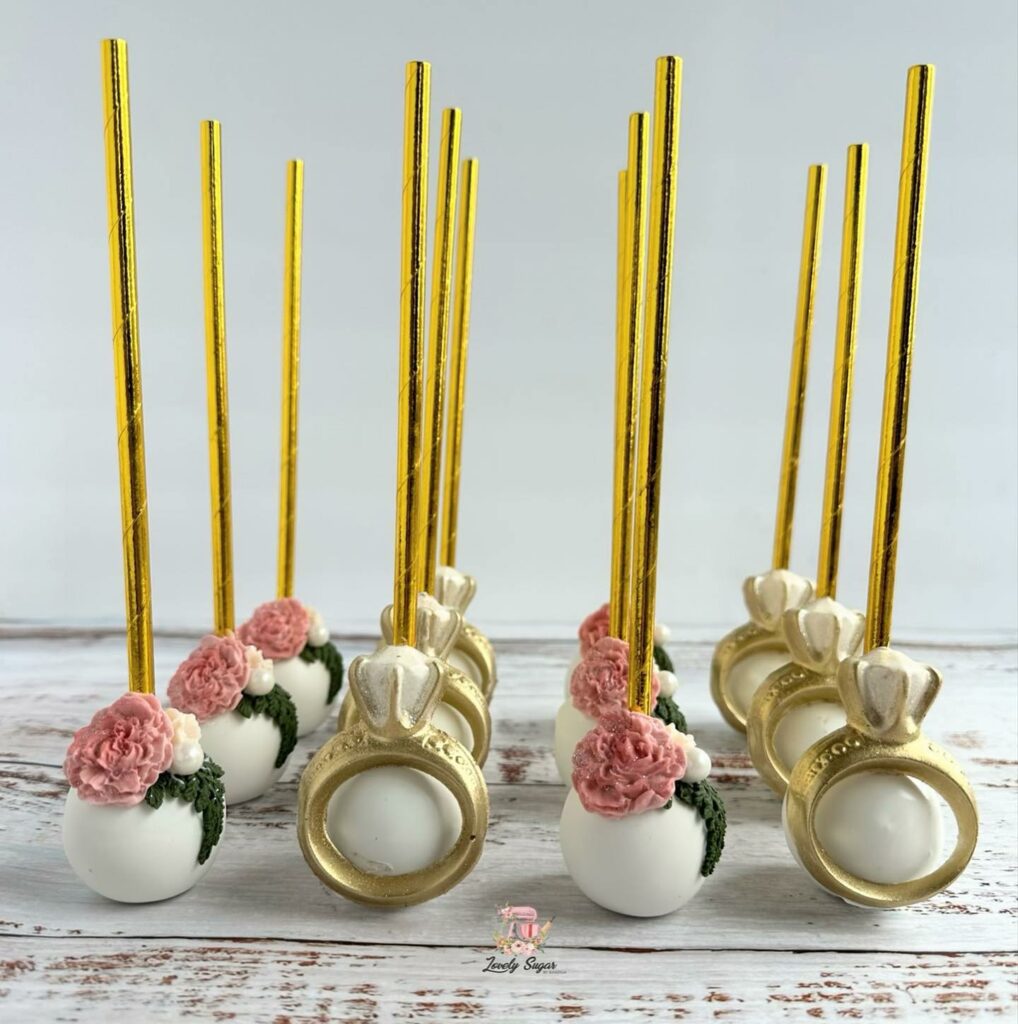 white and gold ring shaped wedding cake pops