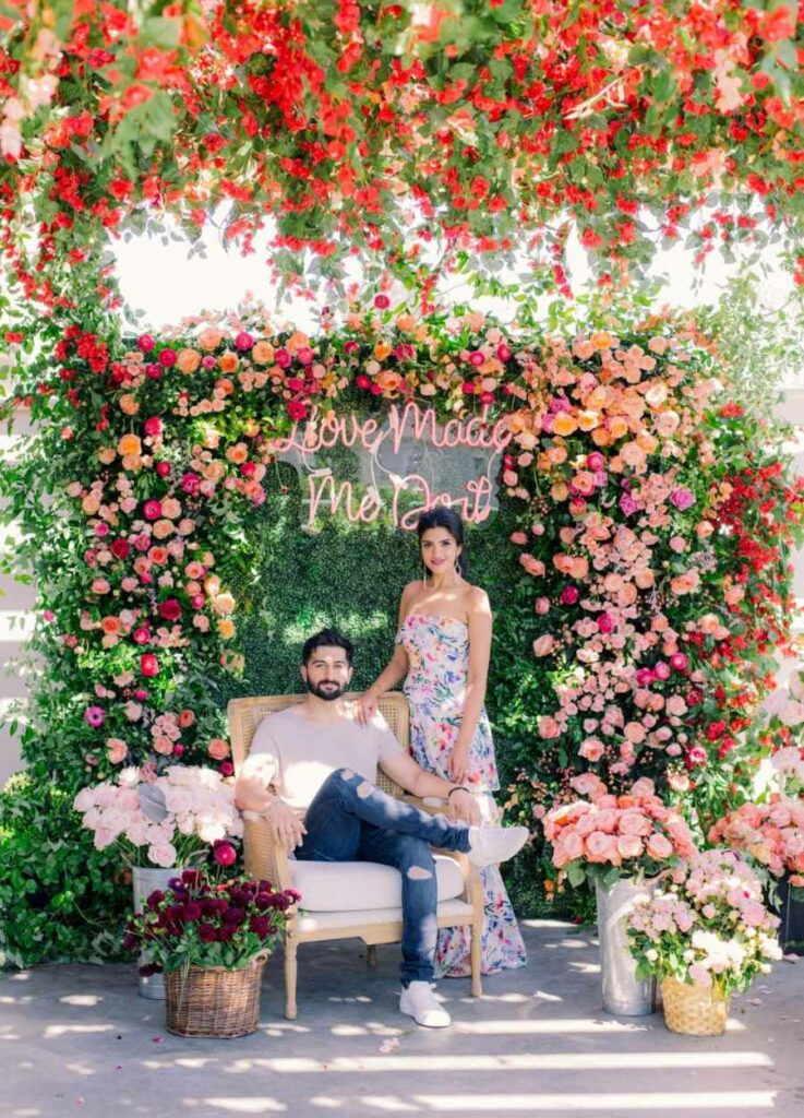 colorful flower walls with neon sign wedding photo booth ideas